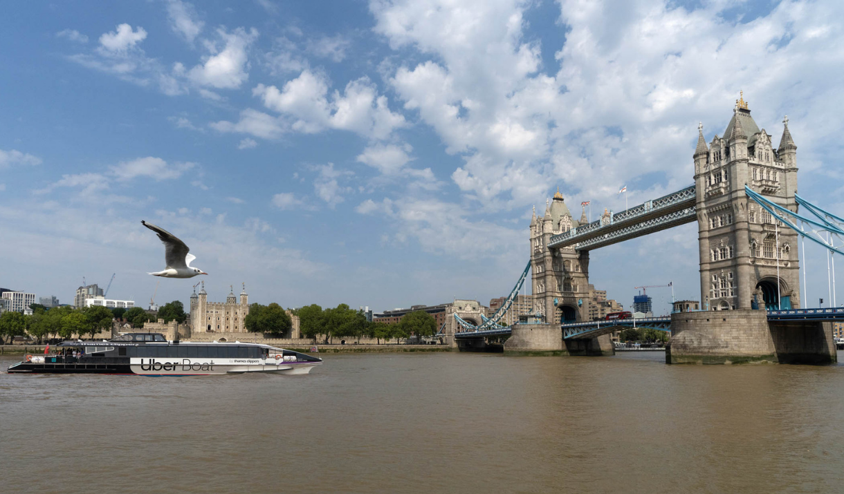 Uber Boat by Thames Clippers sails past Tower Bridge